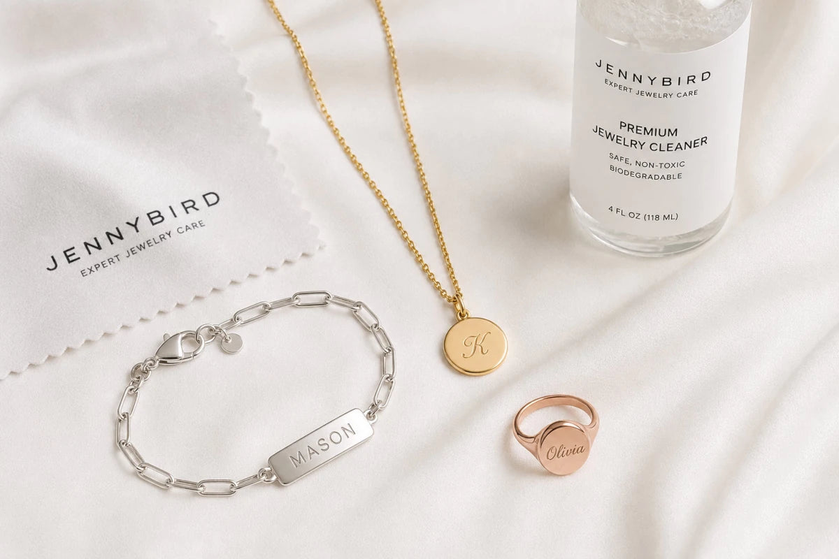Gold, sterling silver, and rose gold personalized jewelry pieces with cleaning supplies