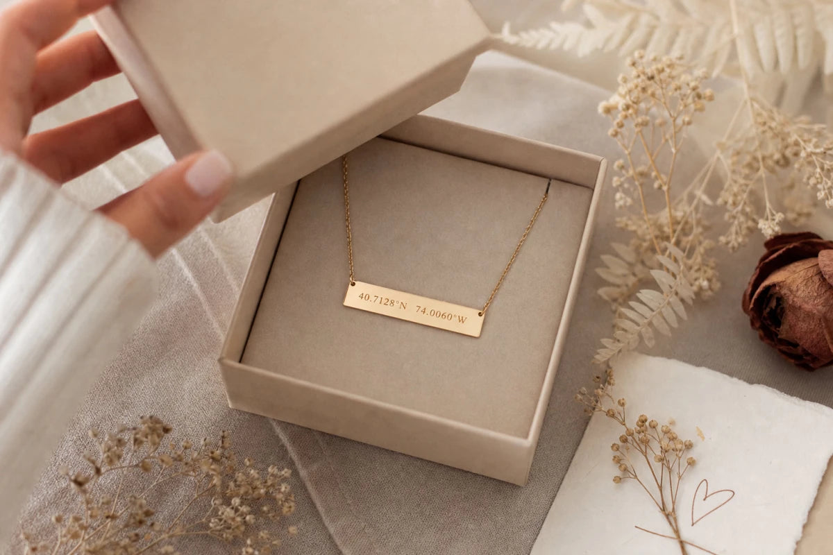 Gold coordinates necklace in premium gift box being opened with dried flowers