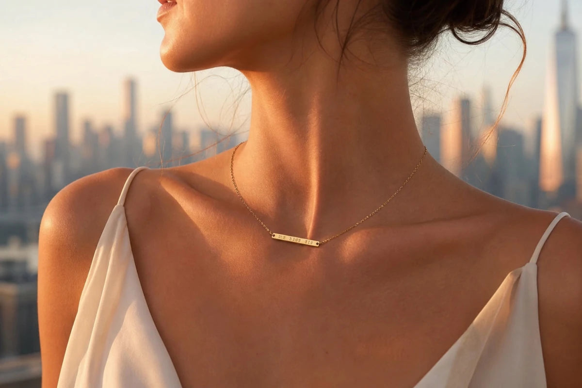 Woman wearing gold coordinates bar necklace in golden hour light - fastest growing gift trend