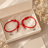 Two red magnetic couple bracelets presented in a gift-ready box