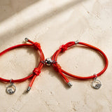 Studio view of two red magnetic couple bracelets