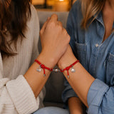 Two people sharing matching red magnetic couple bracelets