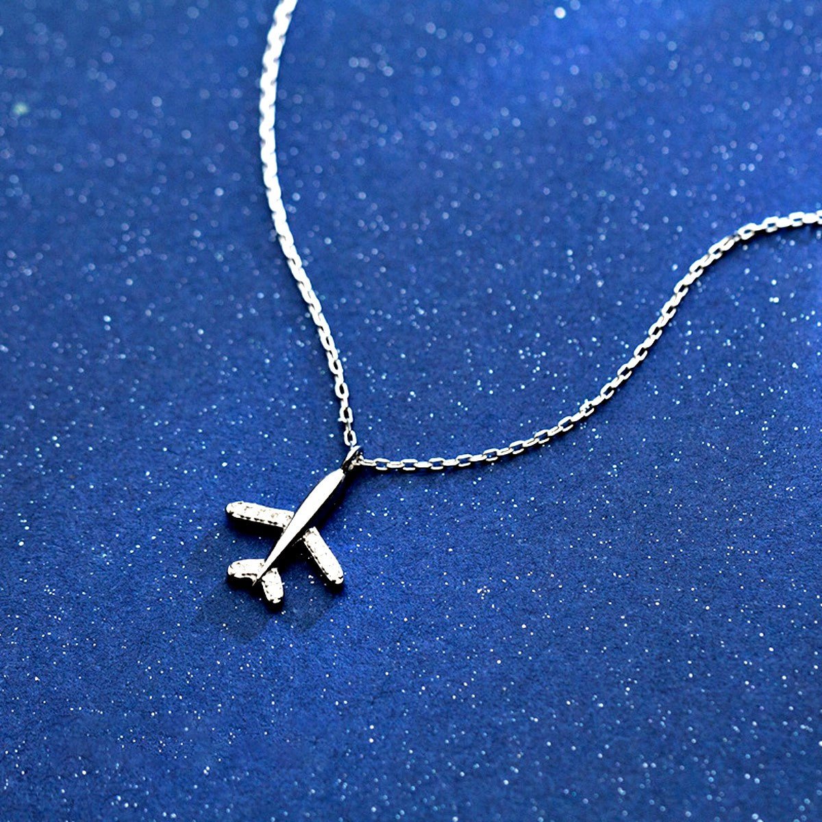 silver airplane necklace